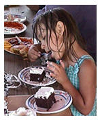 Girl eating dessert at picnic